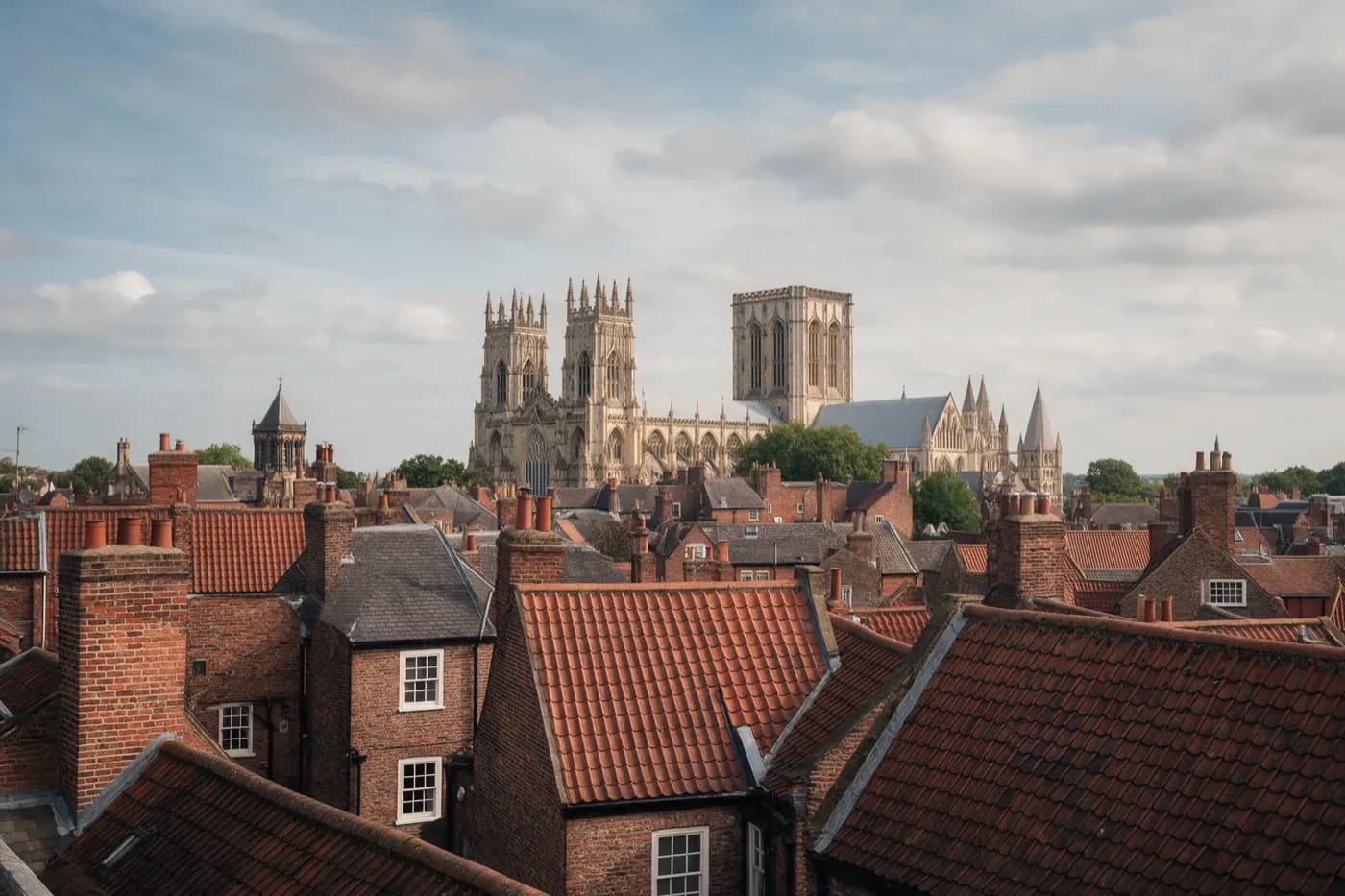 The towers of York Minster above the red-tiled rooftops and chimneys of York
